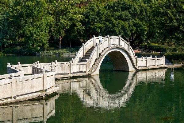 stock image Chinese traditional stone bridge over lake in park