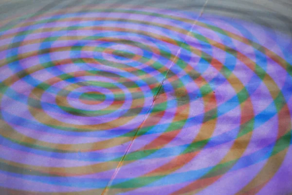 Close-up of colorful ring light projected onto the ground by colorful ring lights
