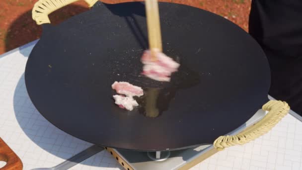 Person Frying Pork Belly Cast Iron Pan Outdoors — Wideo stockowe