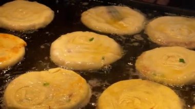 Fried golden beef pancakes are being made at the pancake food stand