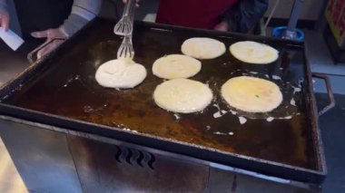 Fried golden beef pancakes are being made at the pancake food stand