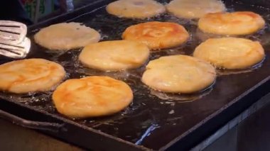 Fried golden beef pancakes are being made at the pancake food stand