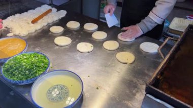 A chef is making beef pancakes