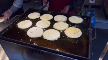Fried golden beef pancakes are being made at the pancake food stand