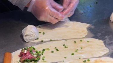 A chef is making beef pancakes