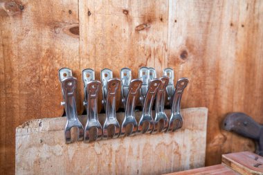 Closeup of a row of iron clips in a tool shed