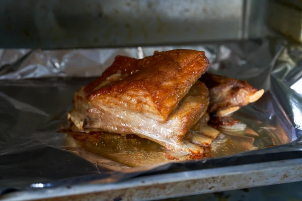 stock image A piece of crispy lamb chops is being baked in the oven