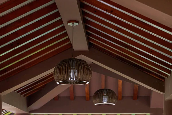 stock image Close up view of rattan chandelier on roof of wooden house