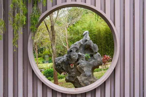 stock image Circular hollow window in modern garden