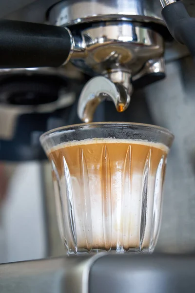 stock image A barista is making a latte with an espresso machine