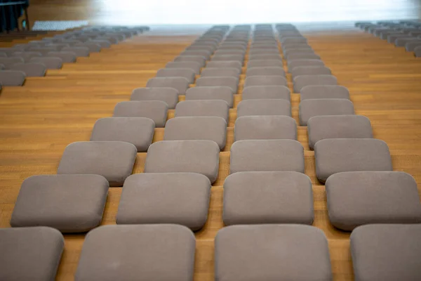 Close-up of cushioned seats in a modern theater auditorium