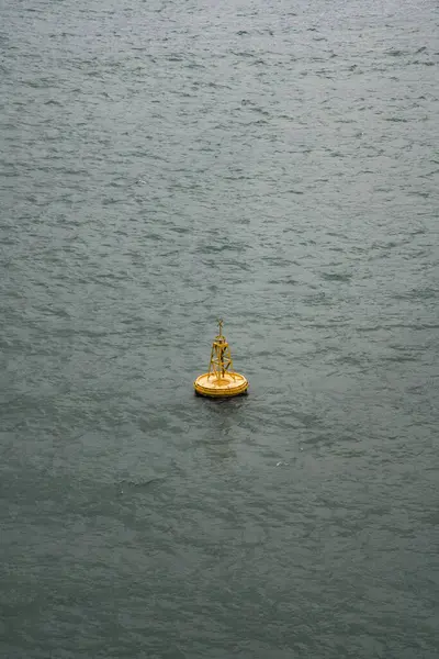 Yellow ship navigation beacon on the sea