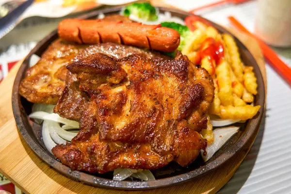Delicious sizzling beef, chicken, and pork chops in a Hong Kong tea restaurant