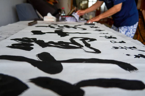 A Chinese calligrapher writes calligraphy and creates a calligraphy work