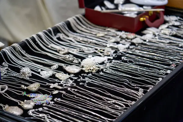 Various silverware and jewelry for sale at market stalls