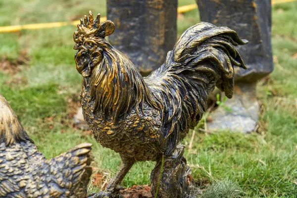 Metal statue of a rooster outdoors