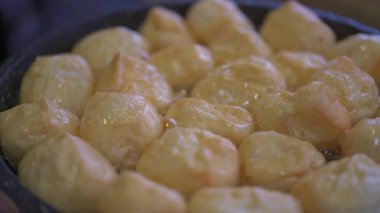 Bir şef tavada tofu kızartıyor, kızarmış tofu, sıcak çömlek malzemeleri.