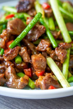 A delicious Chinese home-cooked dish, stir-fried beef with garlic sprouts clipart