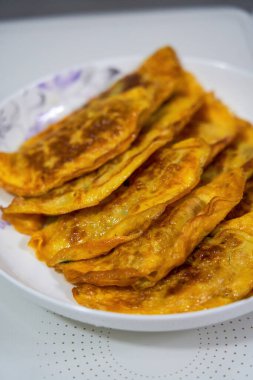 Bir tabak lezzetli kızarmış yumurtalı böreğin yakın çekimi.