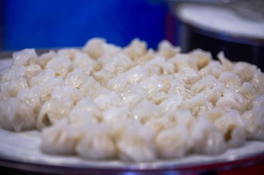 Close-up of steaming dumplings in a steamer at a breakfast shop clipart