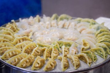 Close-up of steaming dumplings in a steamer at a breakfast shop clipart