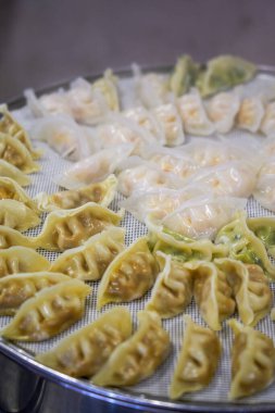 Close-up of steaming dumplings in a steamer at a breakfast shop clipart