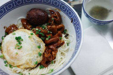 A bowl of delicious Shanghai scallion oil pork intestine noodles clipart