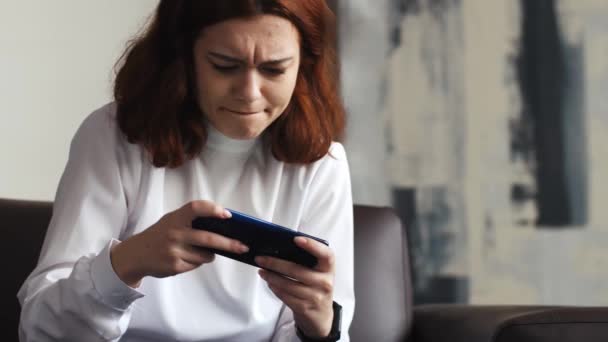 Krásná Roztomilá Mladá Běloška Sedí Pohovce Pomocí Smartphone Šťastně Hrát — Stock video