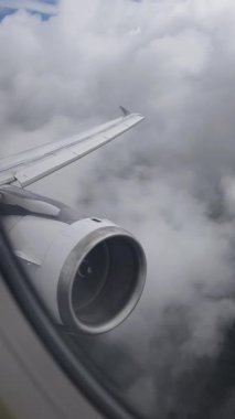 View from the airplane window of a wing with an engine during flight