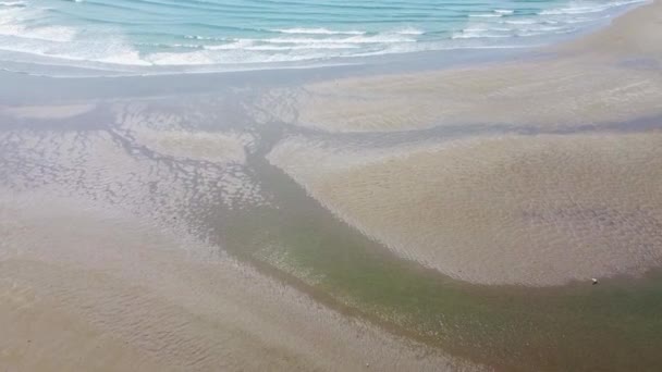 ビーチのぬれた砂や潮汐の海の波の上からの眺め 海面上の砂浜と白い泡無人機のビデオ — ストック動画