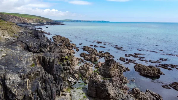 The rocky coast of the island of Ireland. A rocky reef in the Celtic Sea. Beautiful coastline of northern Europe. Nature of Southern Ireland. Drone point of view.