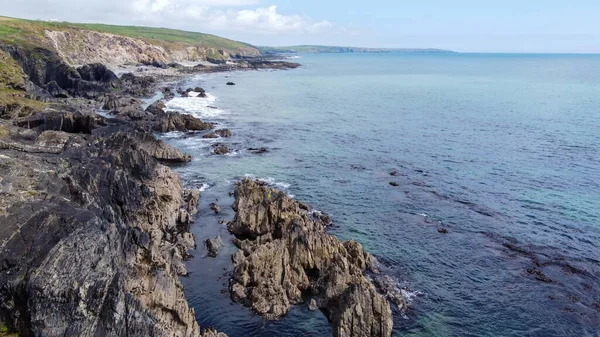 The rocky coast of the island of Ireland. A rocky reef in the Celtic Sea. Beautiful coastline of northern Europe. Nature of Southern Ireland. View from above.