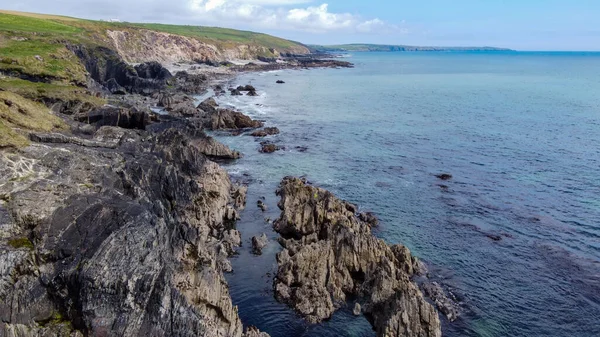 The rocky coast of the island of Ireland. A rocky reef in the Celtic Sea. Beautiful coastline of northern Europe. Nature of Southern Ireland. Aerial photo. Drone point of view.