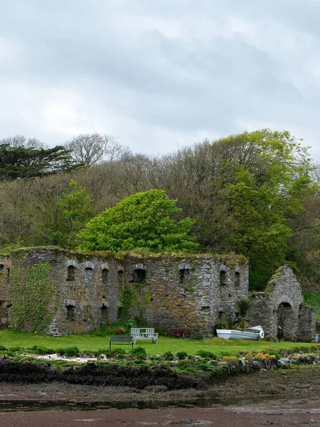 The Arundel grain store, shore of Clonakilty Bay. An stone building in Europe. Historical architectural monument, landscape. Tourist attractions in Ireland