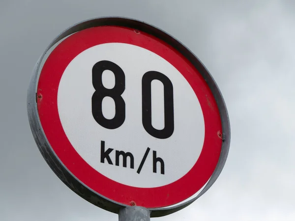 Round sign limiting speed, sky. Signs warning of a maximum speed of 80 km h