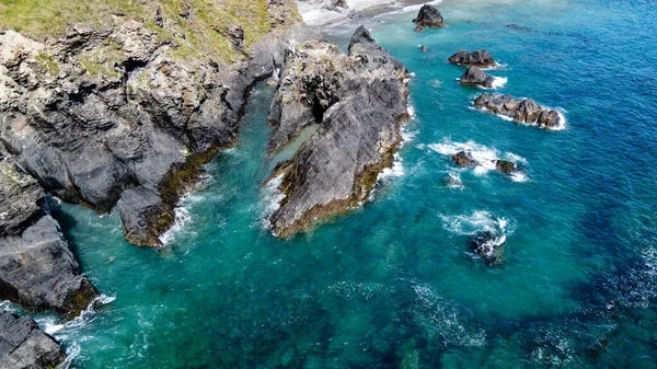 Steep cliffs on the coast of Ireland. Turquoise waters of the Atlantic Ocean. Natural beauties of Ireland, West Cork. The rocky coast of the Celtic Sea. Drone photo.