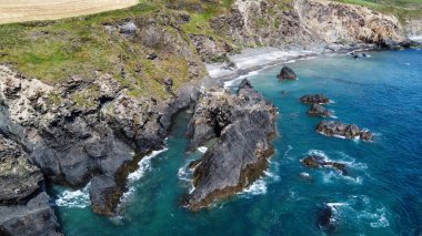 Kıyıdaki sarp kayalıklar. Atlantik Okyanusu 'nun turkuaz suları. İrlanda 'nın doğal güzellikleri, West Cork. Kelt Denizi 'nin kayalık kıyıları.