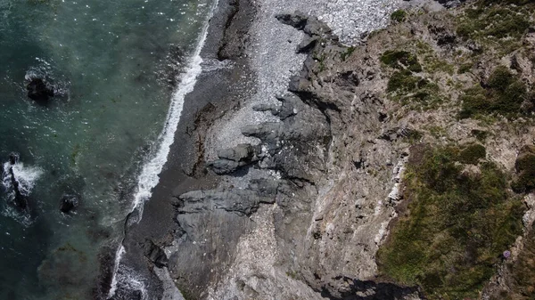 Beautiful beach on the south coast of Ireland near Clonakilty. The picturesque coast of the Celtic Sea. Sea surf. Turquoise waters of the Atlantic. Drone point of view.
