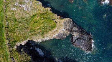 Grassy cliffs on the Atlantic Ocean coast. Landscape of Ireland from a height. Seaside rocks. Drone photo. View from above.