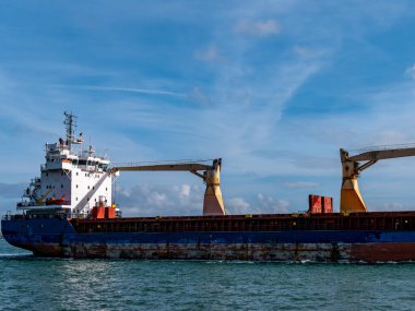 Cobh, Ireland, August 10, 2022. An old rusty big ship is sailing on the sea, sky. cargo ship on sea. Blue and white ship on sea under clear sky. Stern and deckhouse.