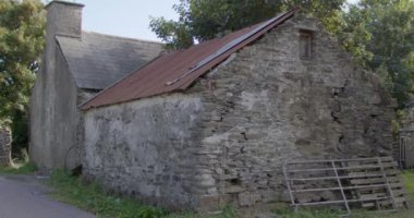 Ruins of old agricultural buildings in the south of Ireland on a summer evening. video.