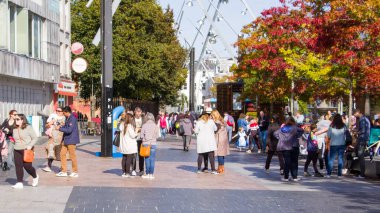 Cork, Ireland, September 30, 2022. People walking on street. street of the Irish city of Cork on a sunny autumn day. City life, streetscape.