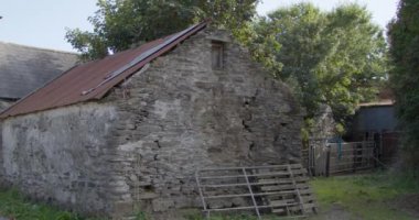 Ruins of old agricultural buildings in the south of Ireland on a summer evening.
