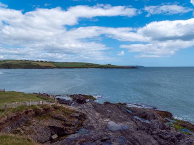Clonakilty Bay under a beautiful cloudy sky on a summer day. Irish seascape, body of water under blue sky.
