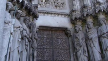 Sculptures of the Holy Apostles near the main entrance to the Cathedral of St. Finbarr in the Irish city of Cork. Statues adorn the facade of the Anglican church. European religious art. Video.
