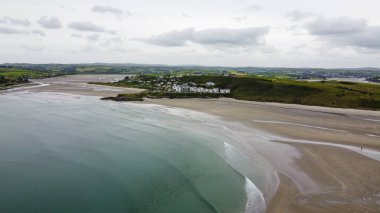 Inchydoney Beach in the Ireland on a cloudy summer day, top view. Seaside landscape. The famous Irish sandy beach. The coastline of the Atlantic Ocean.