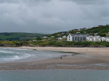 A hotel on the Atlantic Ocean. Inchydoney beach at low tide. Landscape. White concrete building near body of water. Inchydoney Island