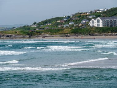 İrlandalılar yaz günü Clonakilty yakınlarında deniz kıyısında dinleniyorlar. Inchydoney plajı, deniz manzarası. Sahildeki insanlar