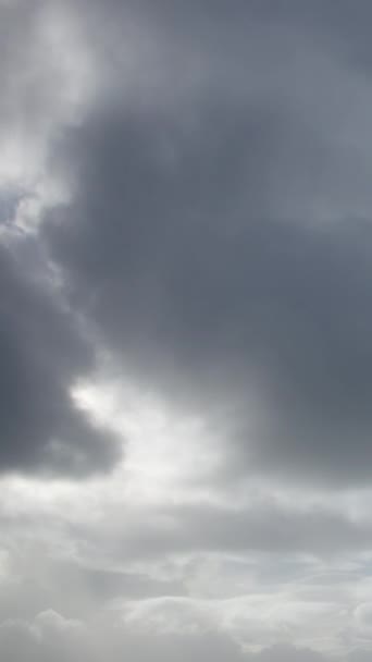 暗い嵐の雲が頭上に集まる 空気は雨の香りで重い ビデオのタイムラプスは 接近する嵐の不吉な美しさを捉えます 垂直ビデオ — ストック動画