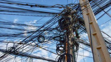 Tangled electrical wires, chaos in the city's power supply system.